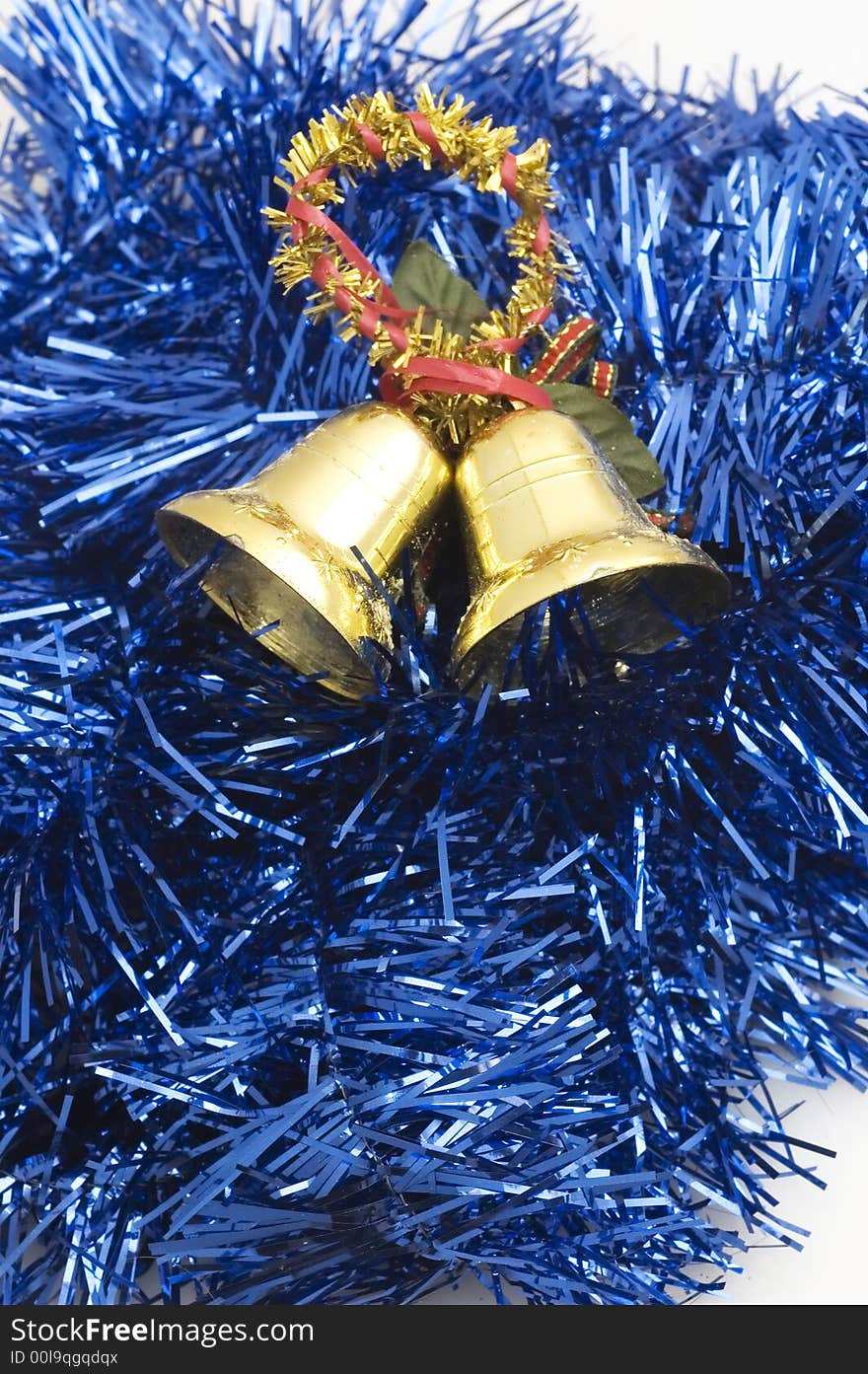 Two golden christmas bells on blue decorated background..