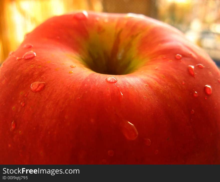 Red apple close-up with drops of water. Fresh