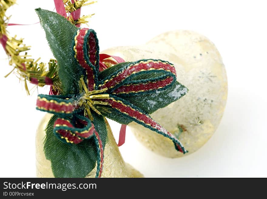 Two golden christmas bells on white background.