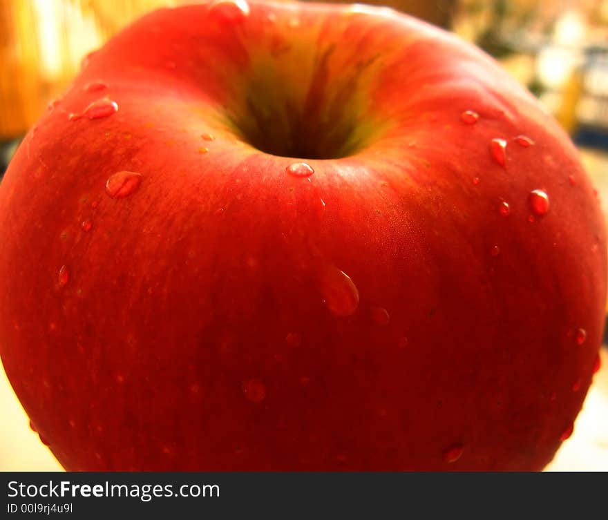 Red apple close-up with drops of water. Fresh