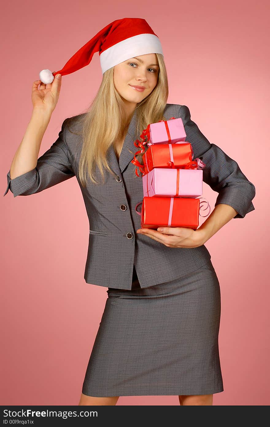 The girl in a New Year's cap with gifts. The girl in a New Year's cap with gifts