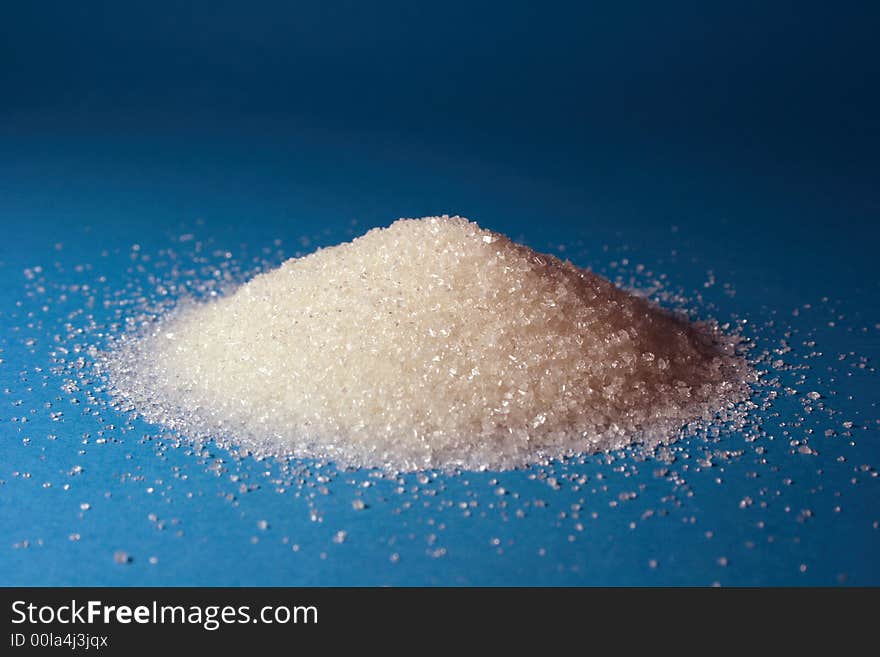 Heap of sugar and a spoon