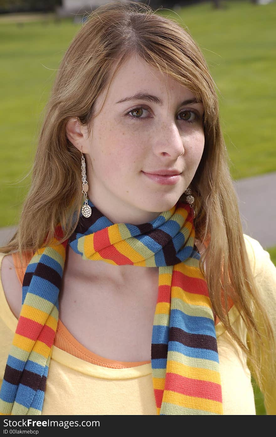 Young beautiful teen outdoors at the park with a different pose. Has a fall or winter season look.