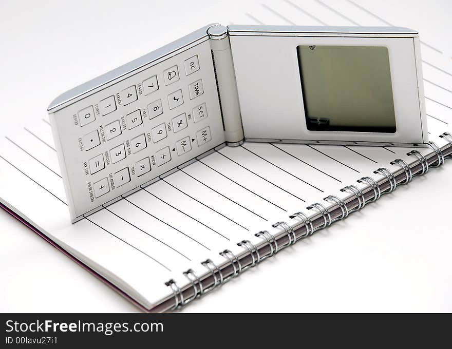 Smart focus a note pad and calculator in the white background