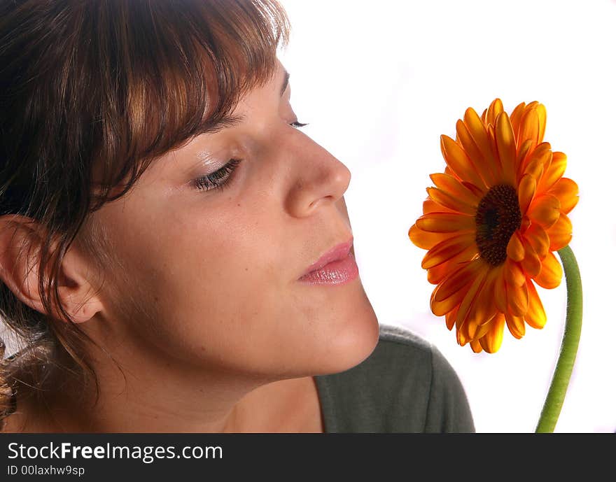 A young woman is smelling the scent of a beautiful flower!. A young woman is smelling the scent of a beautiful flower!