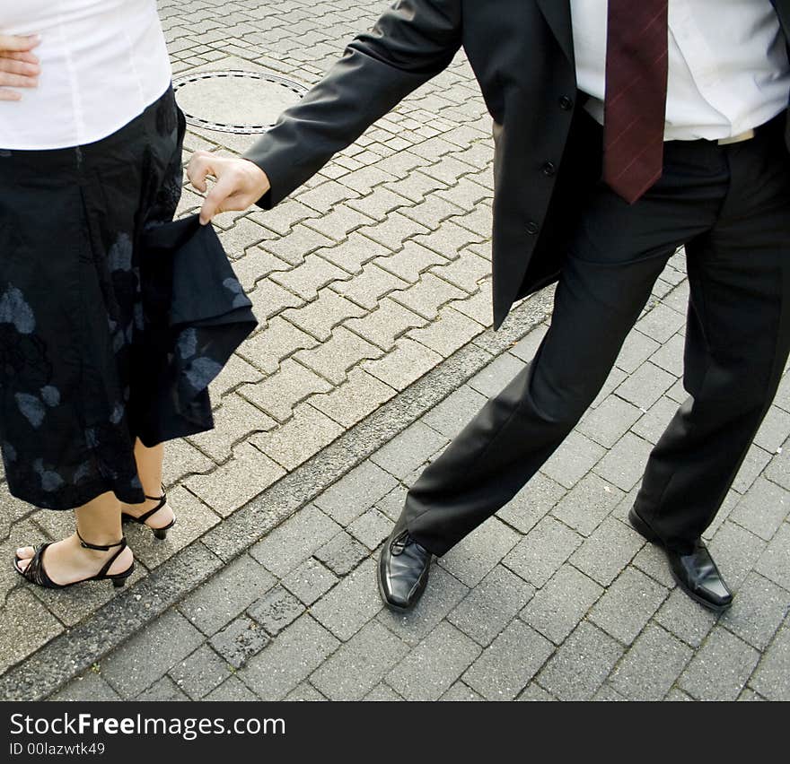 A man lifting a womans skirt. A man lifting a womans skirt