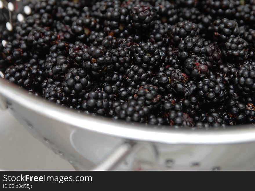 Blackberries in a sieve