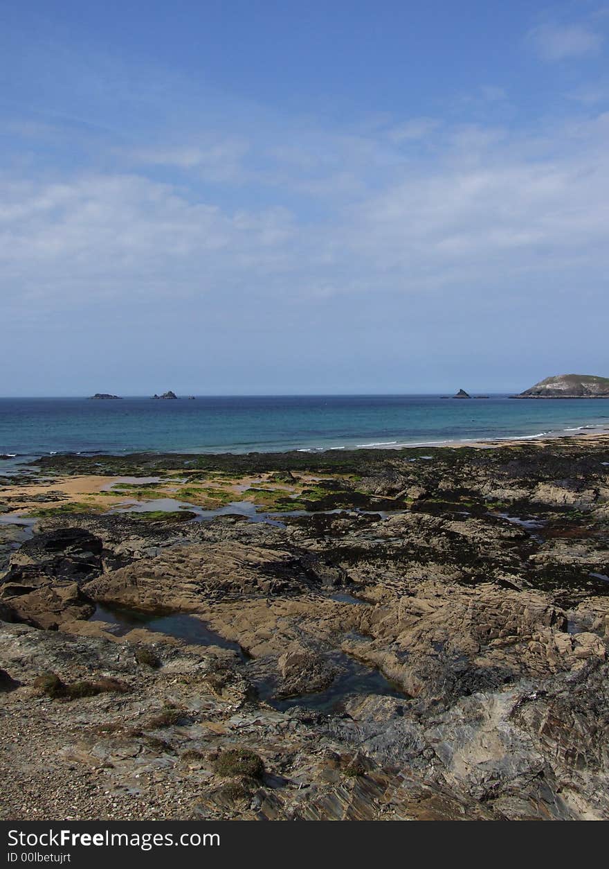 Looking along over rocks to the sea –  Constantine Bay, Cornwall, England