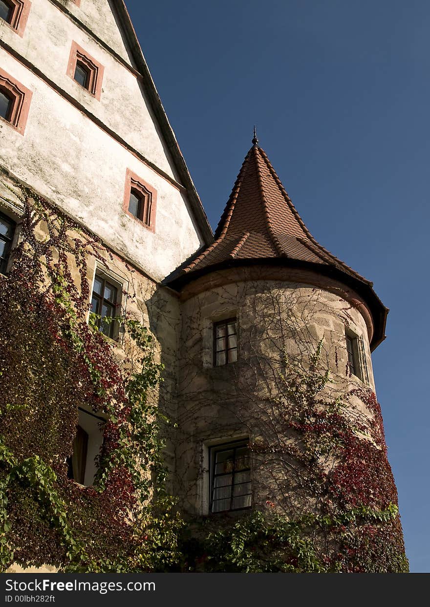 Entwined tower and facade of a German baroque castle. Entwined tower and facade of a German baroque castle