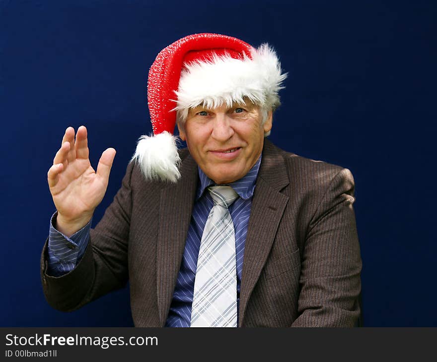 Senior executive giving a Christmas wave to everyone