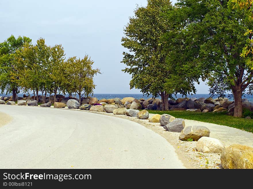 Sidewalk with big rock fence. Sidewalk with big rock fence