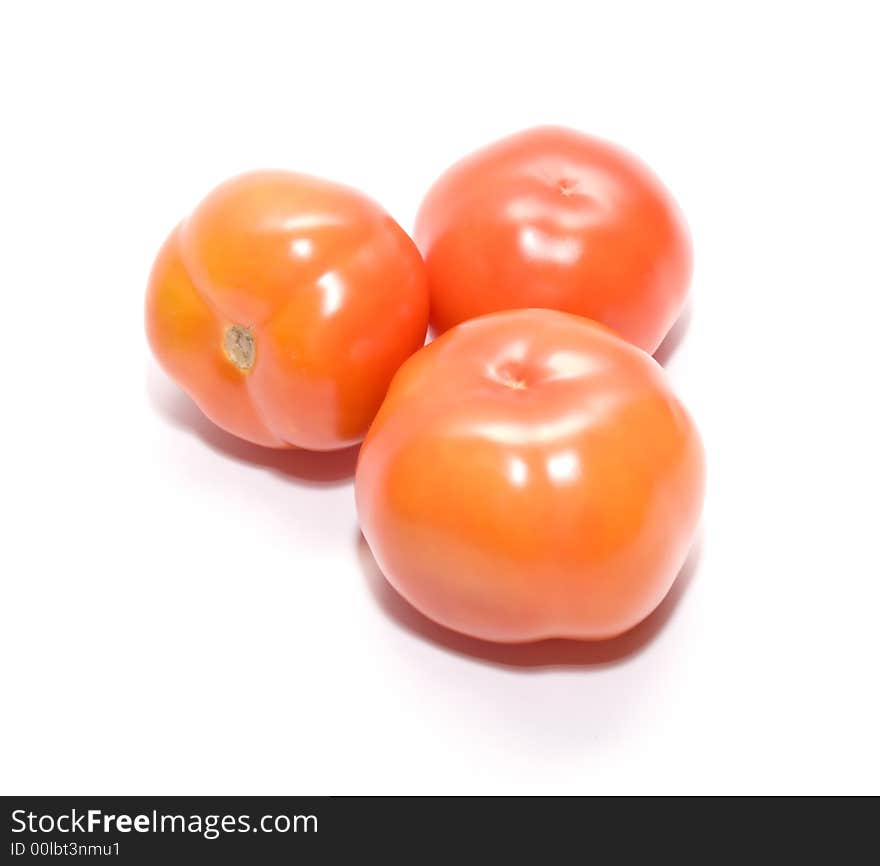 Juicy ripe tomatoes on white. Full isolation on white. Juicy ripe tomatoes on white. Full isolation on white.