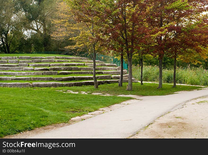 Steps,grass,red dyed maples,evergreen trees,all composited a fall view.