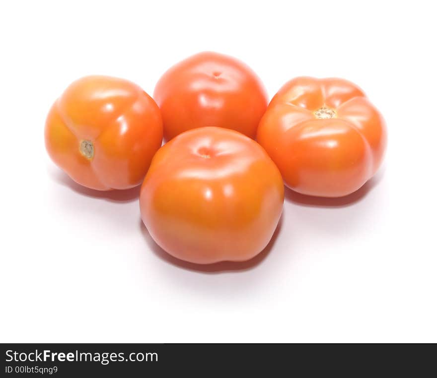 Juicy ripe tomatoes on white. Full isolation on white. Juicy ripe tomatoes on white. Full isolation on white.