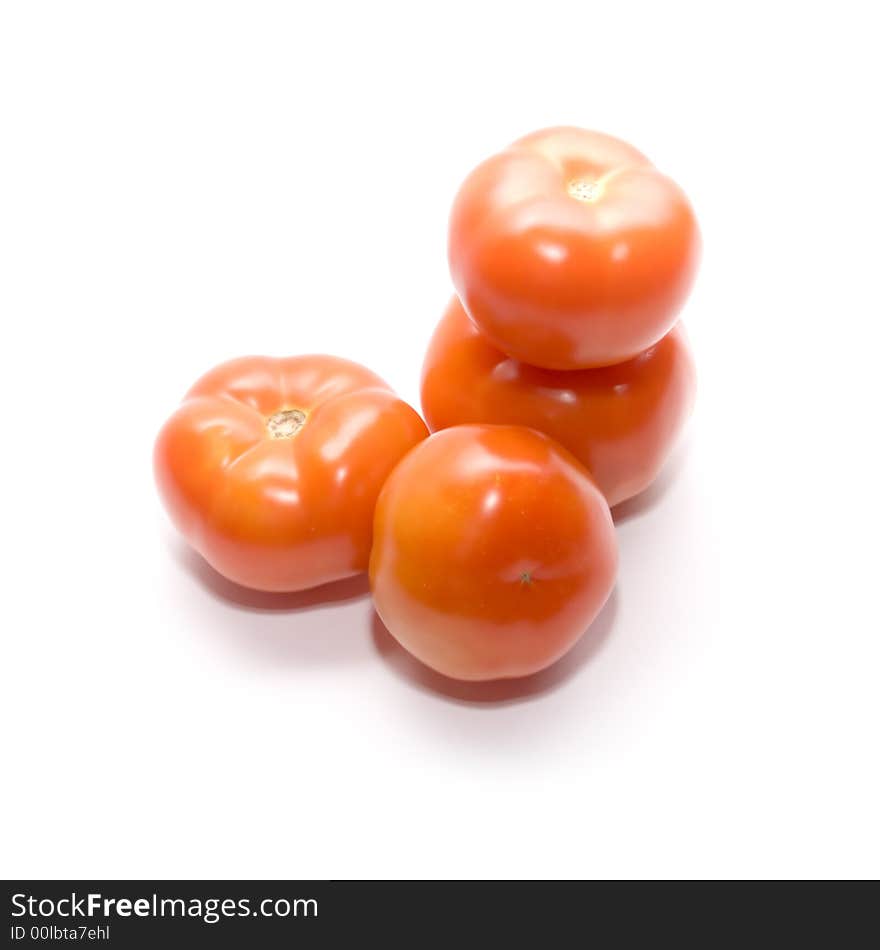 Juicy ripe tomatoes on white. Full isolation on white. Juicy ripe tomatoes on white. Full isolation on white.