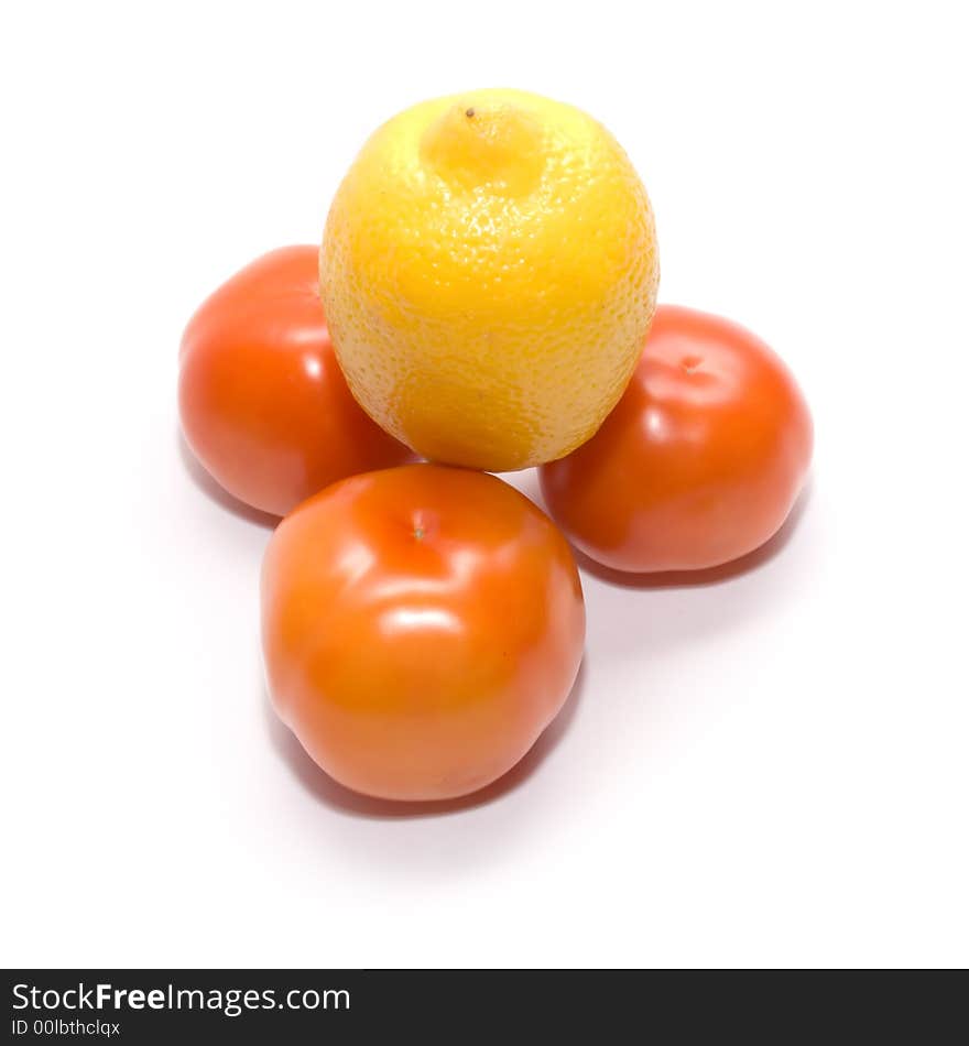 Ripe juicy tomatoes and one lemon. Full isolation on white. Ripe juicy tomatoes and one lemon. Full isolation on white