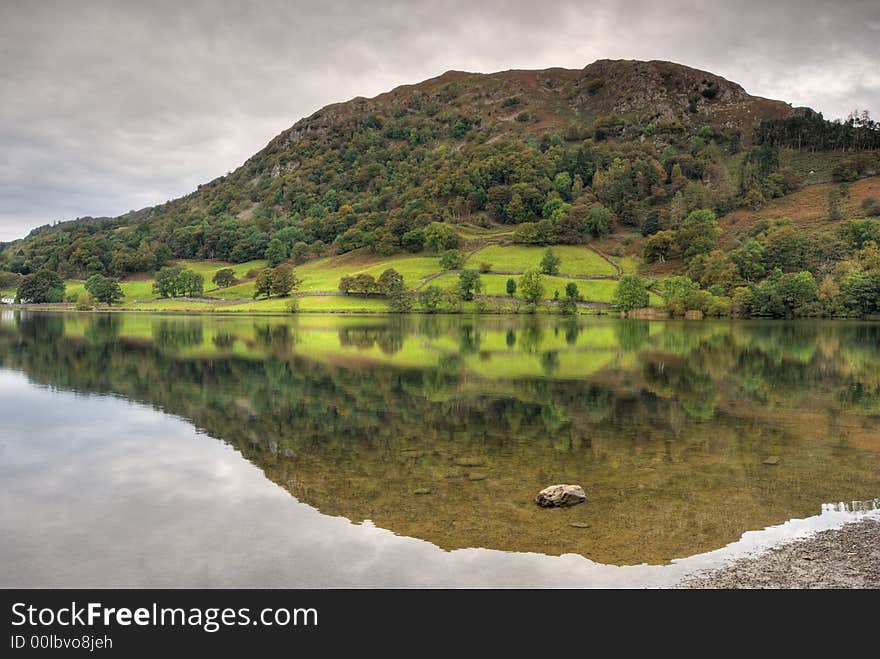 Early Autumn trees reflected in Rydal Water. Early Autumn trees reflected in Rydal Water