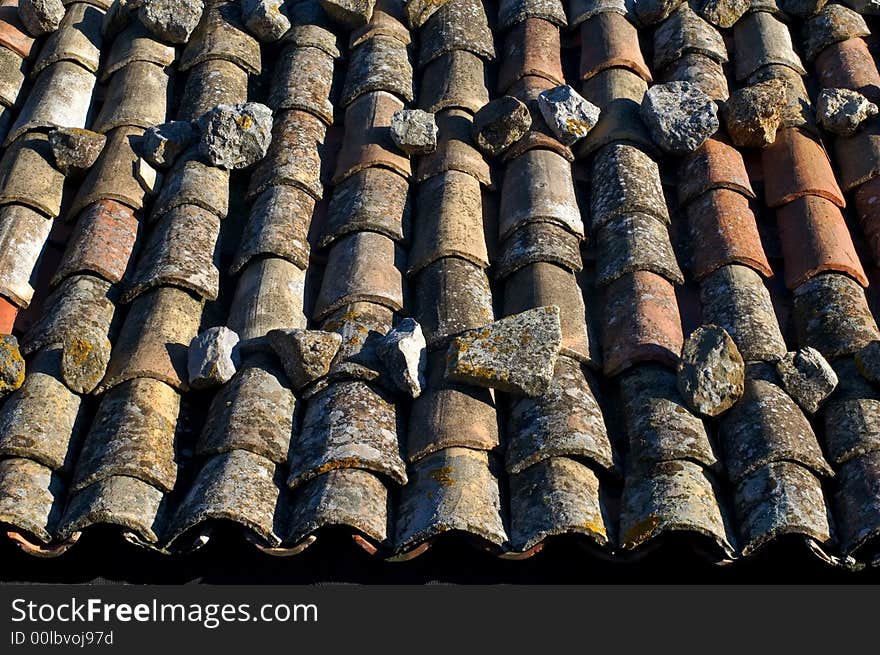 Detail of old roof tiles on Italian building