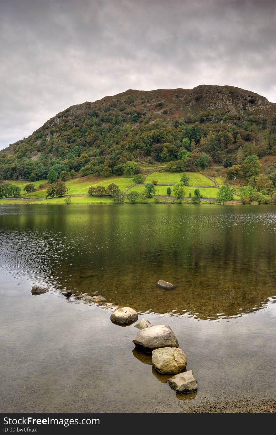 Early Autumn trees reflected in Rydal Water. Early Autumn trees reflected in Rydal Water