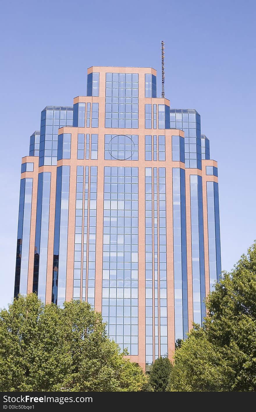 A modern glass and brick building in the trees. A modern glass and brick building in the trees