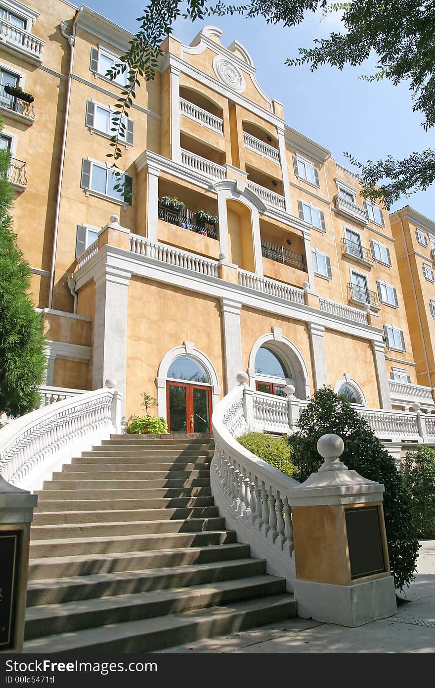 Curved steps rising toward yellow stucco condos. Curved steps rising toward yellow stucco condos