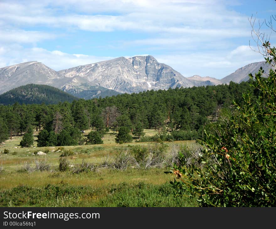 Rocky Mountains blue sky clouds and green trees. Rocky Mountains blue sky clouds and green trees.