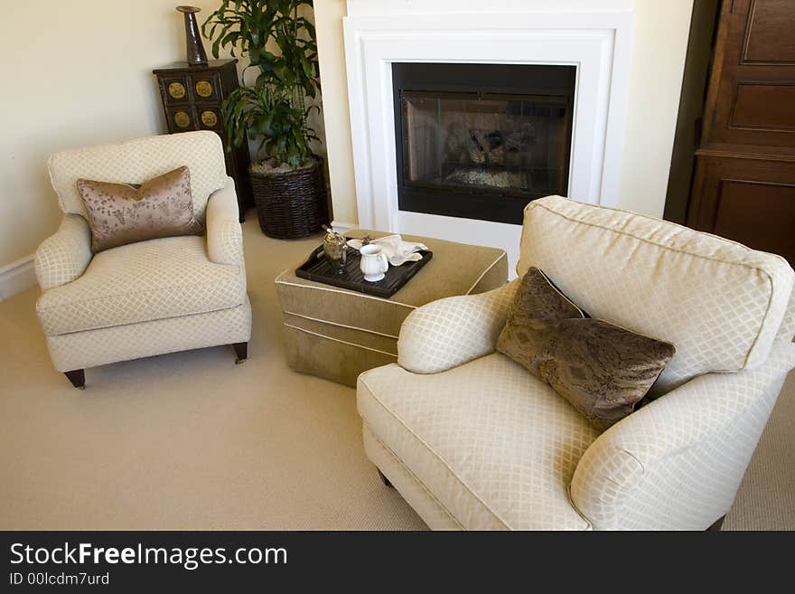 Comfortable bedroom with lounge area and modern fireplace. Comfortable bedroom with lounge area and modern fireplace.