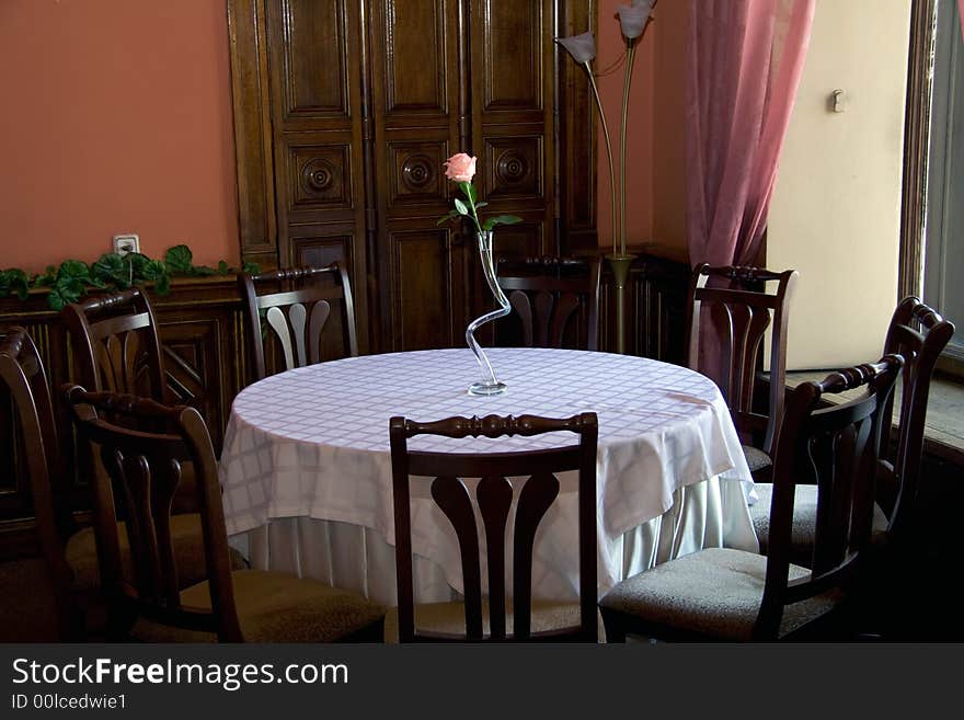 Table with chairs and a flower