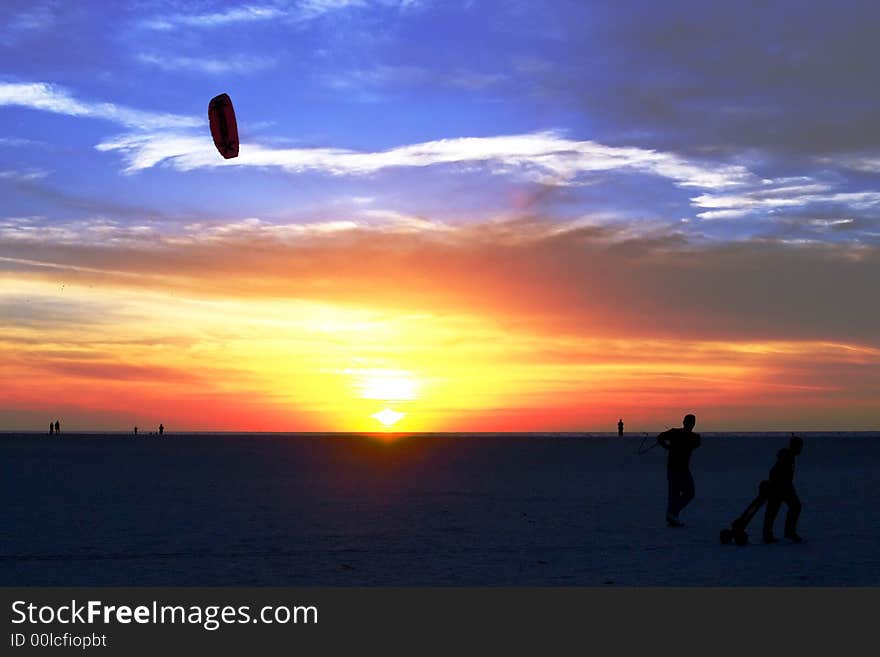 Beach florida orange red sand shadow sunset tropical wind yellow kite kids playing. Beach florida orange red sand shadow sunset tropical wind yellow kite kids playing