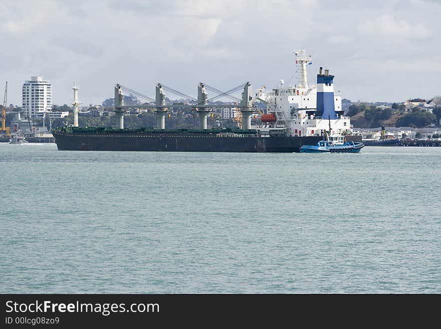 Container Ship being manoeuvred by a Tug Boat. Container Ship being manoeuvred by a Tug Boat