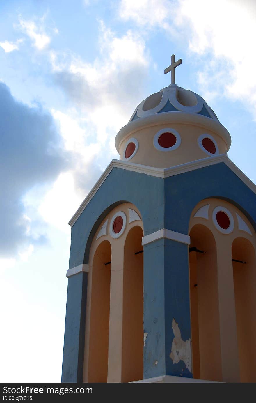 Cross and dome against a cloudy sky