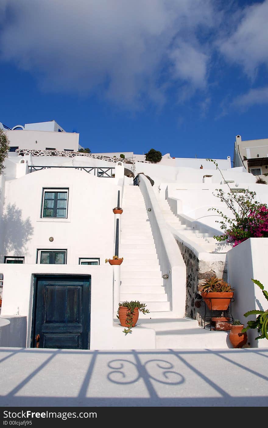 White stairway with terracotta pots in Santorini