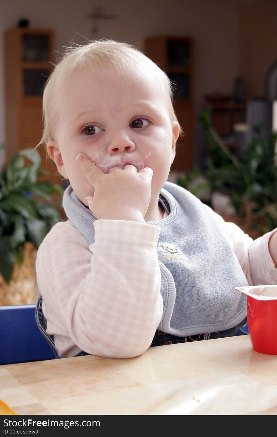 Twenty month old girl tasted yoghurt. Twenty month old girl tasted yoghurt