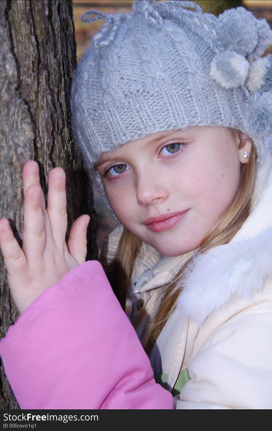 Little girl near tree looking at camera