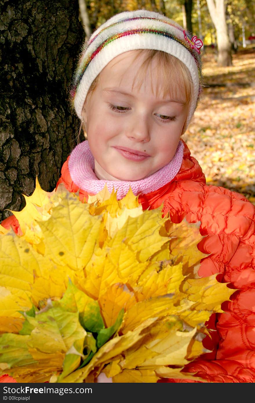 Girl with leafs in hands