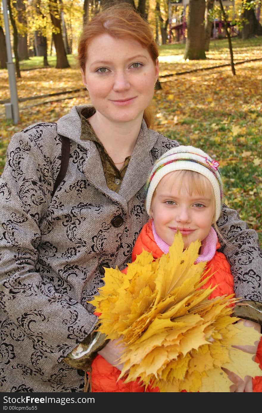 Mother and daughter with leafs