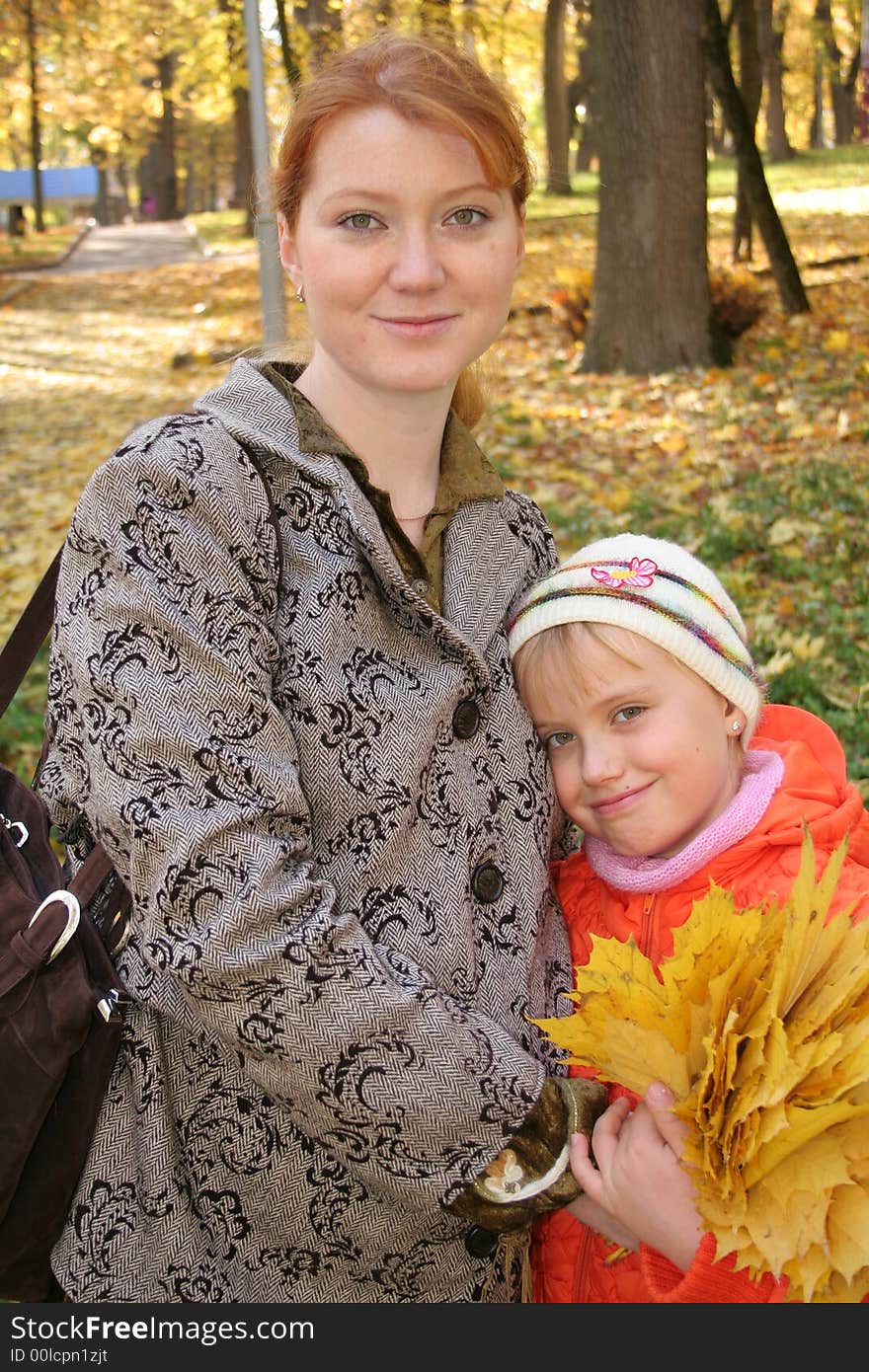 Mother and daughter with leafs