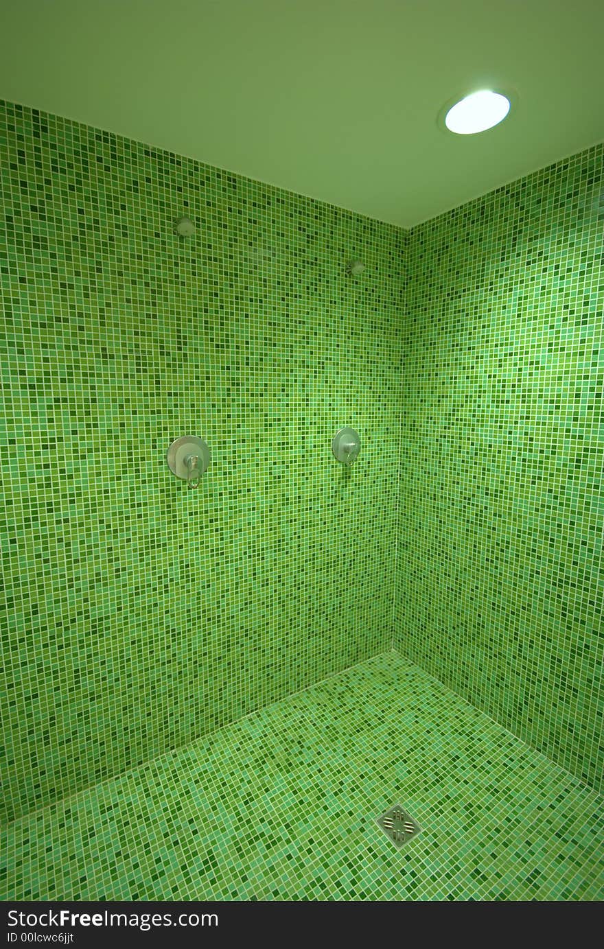 SPA Elegantly decorated public toilet in white and green mosaic - Row of showers and sinks in the sports club bathroom. SPA Elegantly decorated public toilet in white and green mosaic - Row of showers and sinks in the sports club bathroom.