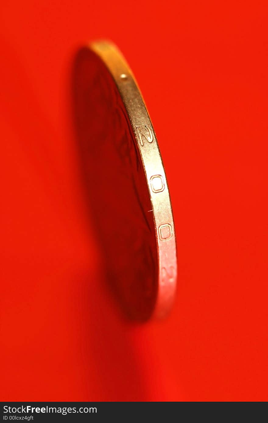 Close-up of coins on red background, macro (shallow DOF)