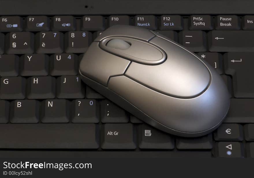 Black keyboard and silver mouse. Black keyboard and silver mouse