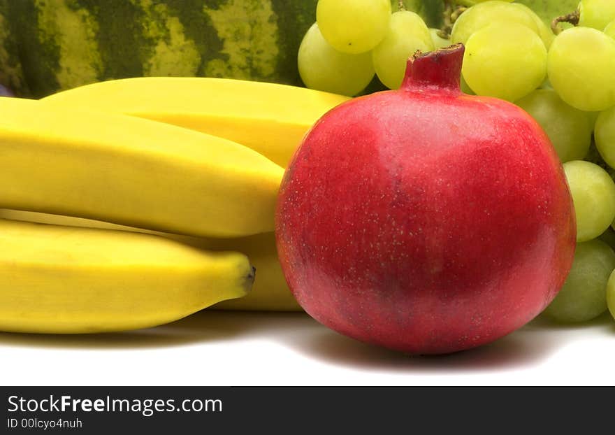 Fresh pomegranate on fruits background