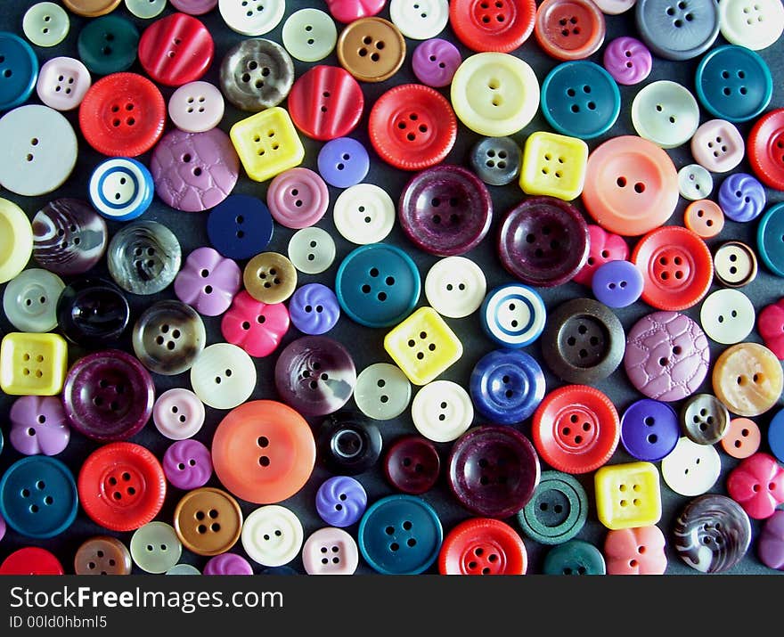 A lot of coloured collar studs on a black ground. A lot of coloured collar studs on a black ground