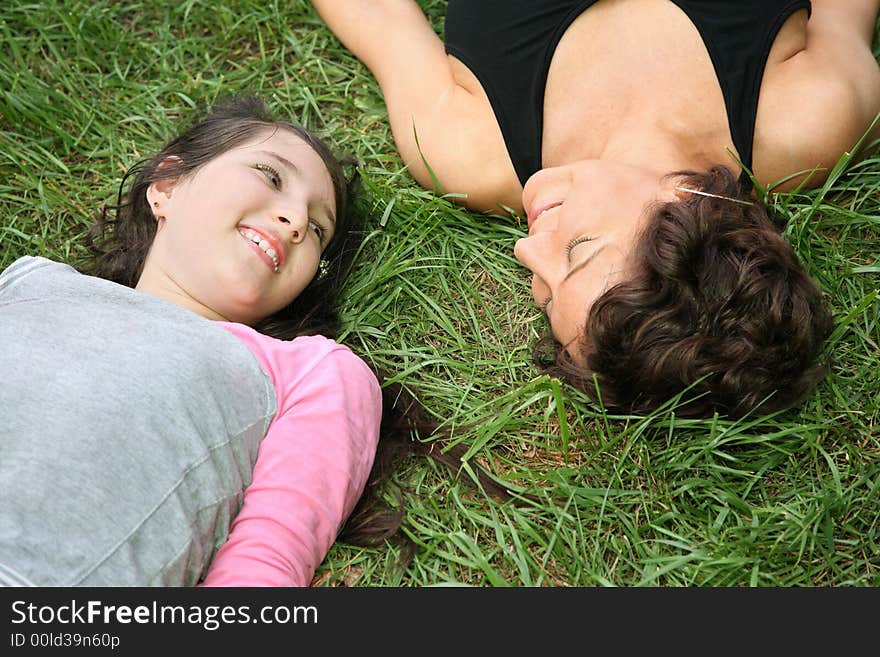 Mother And Daughter On Grass