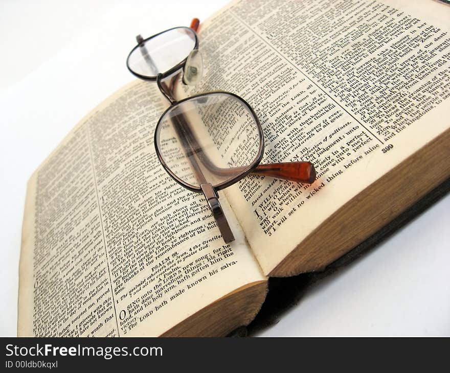 Open book with glasses on a plain background. Open book with glasses on a plain background