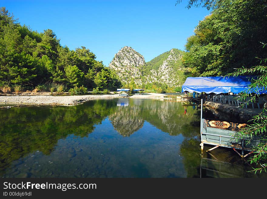 Summer cafe on coast of beautiful mountain lake