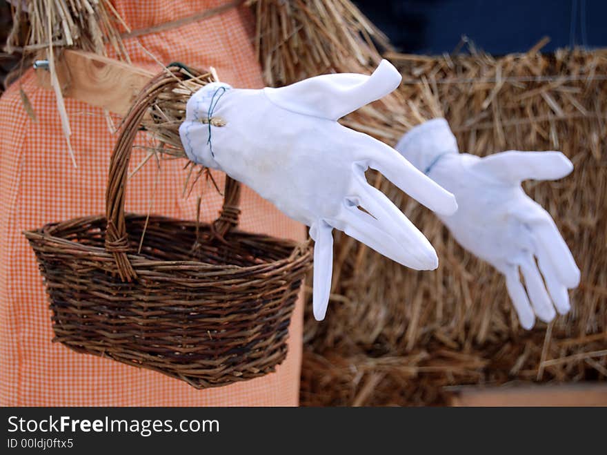 White dress gloves on a scarecrow hands. White dress gloves on a scarecrow hands.