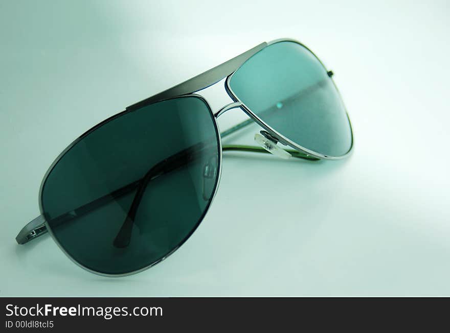 Modern fashionable summer sunglasses with green lenses