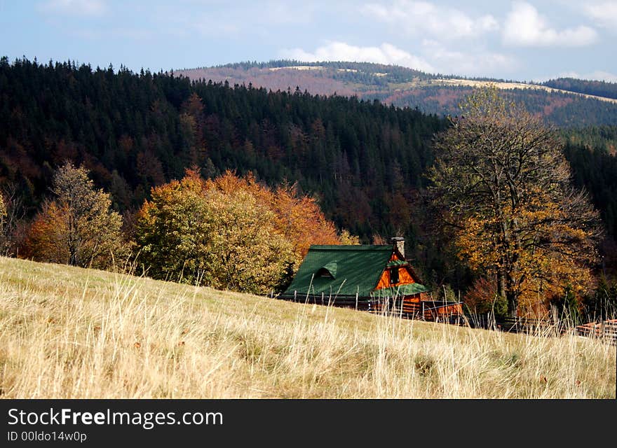 Mountain cottage among forests and meadows in autumn. Mountain cottage among forests and meadows in autumn