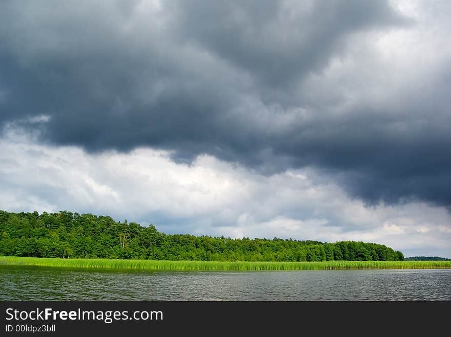 Stormy clouds over the lake. Mazury, Poland. Stormy clouds over the lake. Mazury, Poland.