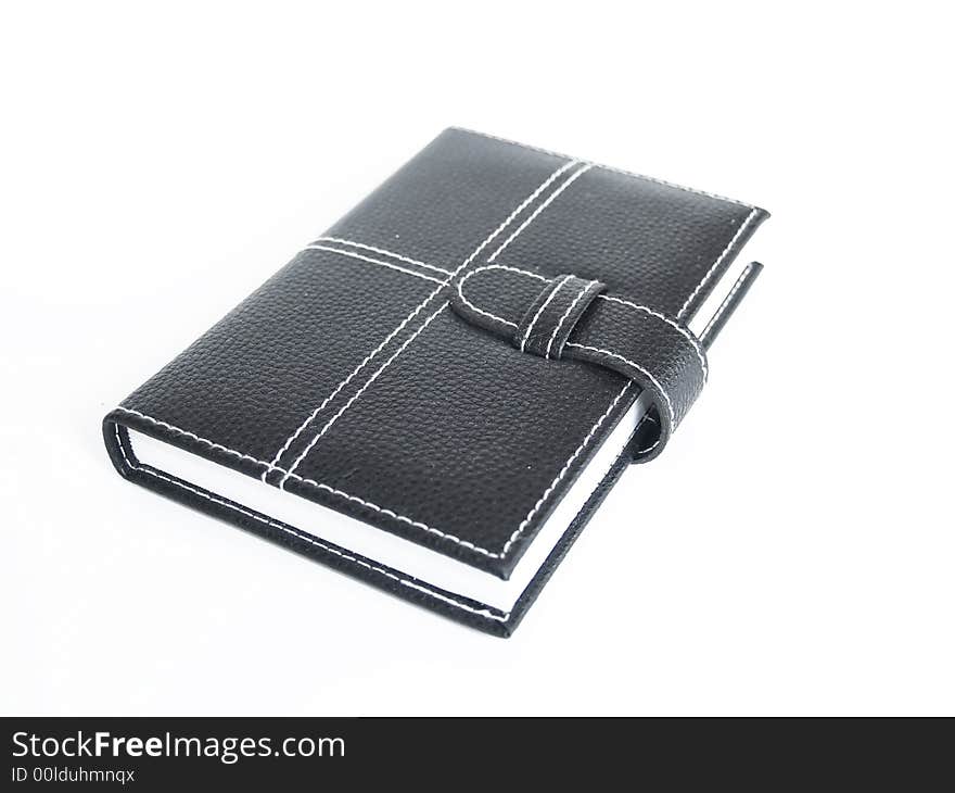 Black leather cased notebook, on white bacground with pen for writing. Black leather cased notebook, on white bacground with pen for writing.